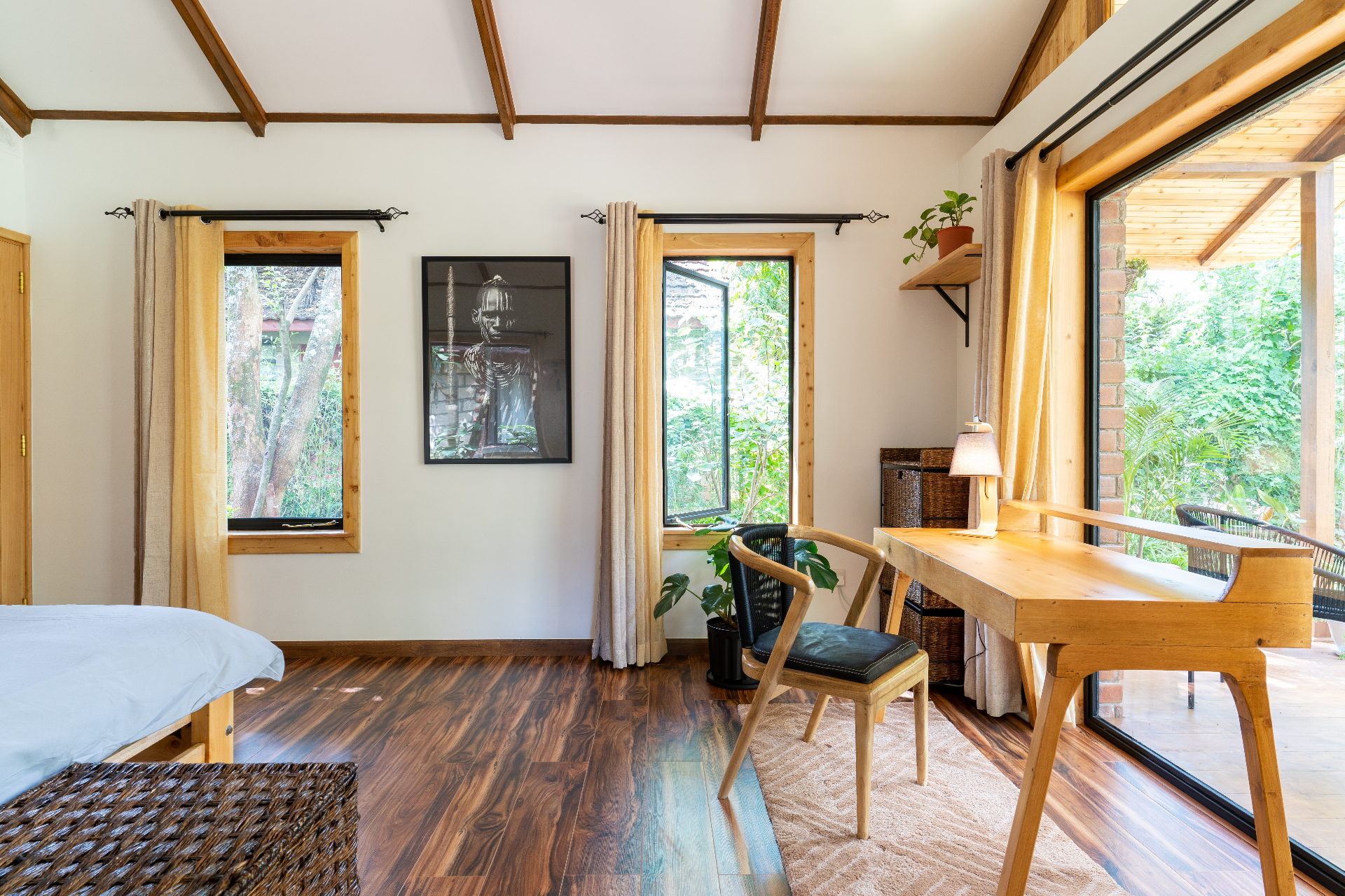 Compact en suite bathroom with timber vanity, walk-in shower, exposed-brick divider and open shelving with folded towels